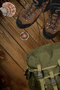 Hiking boots, compass and backpack on background