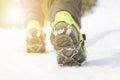 Hiking boots with equipment for ice. Snow like a background and sun. Sun is shining. Moutains and travel. Royalty Free Stock Photo