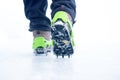 Hiking boots with equipment for ice. Snow like a background and sun. Sun is shining. Moutains and travel. Royalty Free Stock Photo