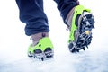 Hiking boots with equipment for ice. Snow like a background and sun. Sun is shining. Moutains and travel. Royalty Free Stock Photo