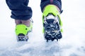 Hiking boots with equipment for ice. Snow like a background and sun. Sun is shining. Moutains and travel. Royalty Free Stock Photo