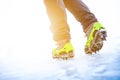 Hiking boots with equipment for ice. Snow like a background and sun. Sun is shining. Moutains and travel. Royalty Free Stock Photo