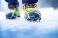 Hiking boots with equipment for ice. Snow like a background and sun. Sun is shining. Moutains and travel. Royalty Free Stock Photo