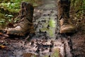 hiking boots leaving muddy footprints on path
