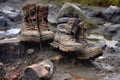 hiking boots leaving muddy footprints on rocks