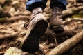 Hiking boots and legs. Man walking on the mountain green path in dark forest. Royalty Free Stock Photo