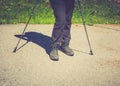 Hiking boots in outdoor action. sticks in the mountains.