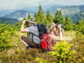 Hiking couple admiring mountain vistas through binoculars