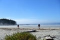 A hiking couple arriving to an incredible view of the sandy beaches of nels, surrounded by forest and the pacific ocean Royalty Free Stock Photo