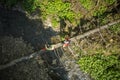 Hiking Couple Crossing River Walking Along Fallen Tree Aerial View Royalty Free Stock Photo