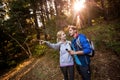 Hiking couple holding a compass and pointing forward Royalty Free Stock Photo