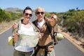 Hiking couple looking at map on the road Royalty Free Stock Photo