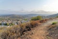 Hiking dirt trail near the grassy edge of a slope at Double Peak Park in Sam Marcos, California