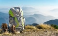 Hiking equipment. Backpack and boots on top of mountain. Royalty Free Stock Photo