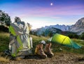 Hiking Equipment, Tent, Backpack and Boots under a moon night sky at amazing twilight hour. Alps, Triglav National Park Royalty Free Stock Photo