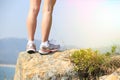 Hiking feet stand seaside rock Royalty Free Stock Photo