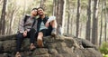 Hiking, forest and nature couple people on rock for journey, adventure or wellness lifestyle with trees, fitness gear Royalty Free Stock Photo