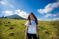 Hiking girl on top of hill with hands up enjoy mountain view. Royalty Free Stock Photo