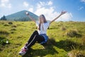 Hiking girl on top of hill with hands up enjoy mountain view. Royalty Free Stock Photo