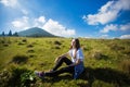 Hiking girl on top of hill with hands up enjoy mountain view. Royalty Free Stock Photo