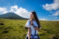 Hiking girl on top of hill with hands up enjoy mountain view. Royalty Free Stock Photo