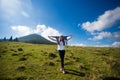 Hiking girl on top of hill with hands up enjoy mountain view Royalty Free Stock Photo