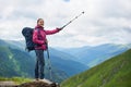Hiking girl stands on rock against mighty mountains Romania