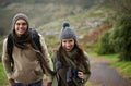 Hiking is good for the soul. A young couple wrapped up warmly and hiking on a mountain trail together. Royalty Free Stock Photo