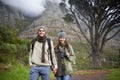 Hiking is good for the soul. A young couple wrapped up warmly and hiking on a mountain trail together. Royalty Free Stock Photo