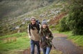 Hiking is good for the soul. A young couple wrapped up warmly and hiking on a mountain trail together. Royalty Free Stock Photo