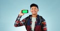 Hiking, green screen and man with a smartphone, portrait and backpack on a blue studio background. Person, hiker and