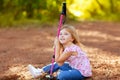 Hiking kid girl tired sitting in autumn forest