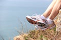 Hiking legs sit seaside rock Royalty Free Stock Photo