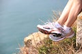 Hiking legs sit seaside rock Royalty Free Stock Photo