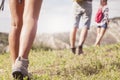 Hiking legs walking on mountain grass Royalty Free Stock Photo