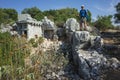 Hiking Lycian way. Man is standing on ruins of ancient city of Phellos on Lycian way trail, Trekking in Turkey, outdoor activity