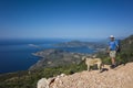 Hiking Lycian way. Man tourist and dog stand on path over Mediterranean sea coast on Lycian Way trail