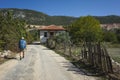 Hiking Lycian way. Man is trekking through Bezirgan village on Lycian Way trail along old broken ragged fence