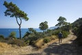 Hiking Lycian way. Man is trekking on dirt road along Mediterranean sea coast, Outdoor activity in Turkey