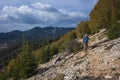 Hiking on the Lycian Way. Man is trekking on steep stony slope of covered with trees mountain, Trail from Alakilise Ruins Royalty Free Stock Photo