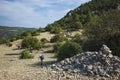 Hiking Lycian way. Man is walking on dry stony highland on stretch between Kalkan and Kas of Lycian way trail, Trekking