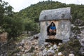 Hiking Lycian way. Tourist posing for photo inside Lycian rock tomb, stretch between Myra - Alakilise Ruins, Trekking in Turkey