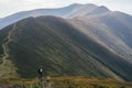 Hiking man, climber or trail runner in mountains, inspirational landscape. Motivated hiker looking at mountain view. Royalty Free Stock Photo