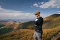 Hiking man, climber or trail runner in mountains, inspirational landscape. Motivated hiker looking at mountain view. Royalty Free Stock Photo