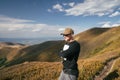 Hiking man, climber or trail runner in mountains, inspirational landscape. Motivated hiker looking at mountain view. Royalty Free Stock Photo