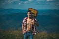 Hiking man. Motivated hiker with guitar looking at beautiful view. Trekking, travel and tourism concept. Fitness and