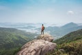 Hiking man standing on the rock, mountain peak. Sai Kung, Hong Kong Royalty Free Stock Photo