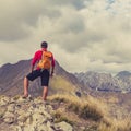 Hiking man or trail runner in mountains Royalty Free Stock Photo