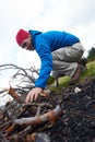 Hiking man try to light fire Royalty Free Stock Photo