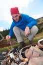 Hiking man try to light fire Royalty Free Stock Photo